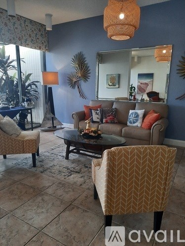 A living room with a sofa, armchair, and coffee table.