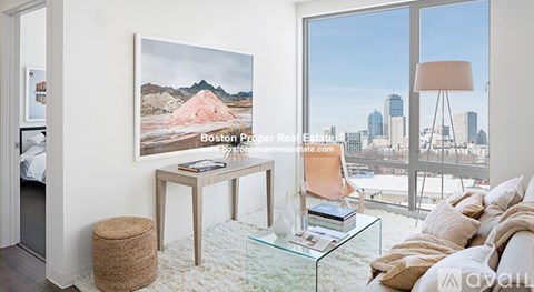 A modern living room with a glass table and a large window overlooking the city.