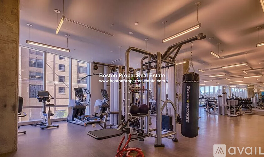 A gym with a variety of equipment including a punching bag.