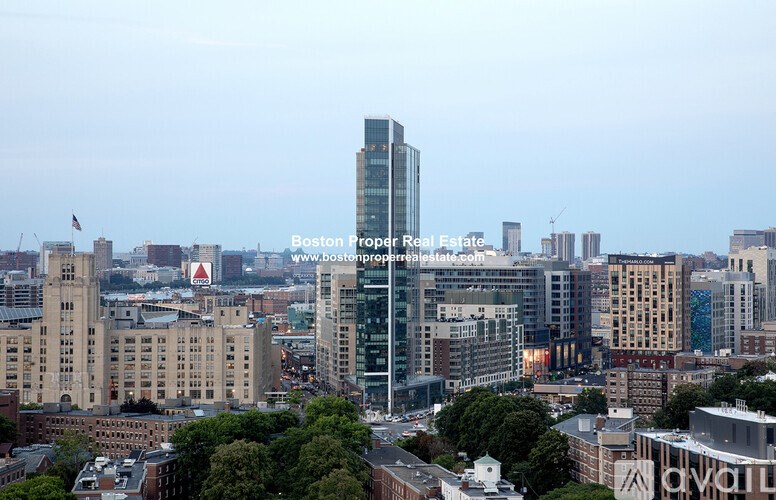 A cityscape with a tall building in the center and a website address at the bottom.