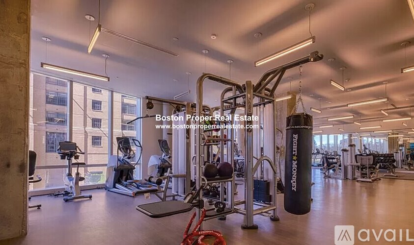 A gym with a variety of equipment including a punching bag.