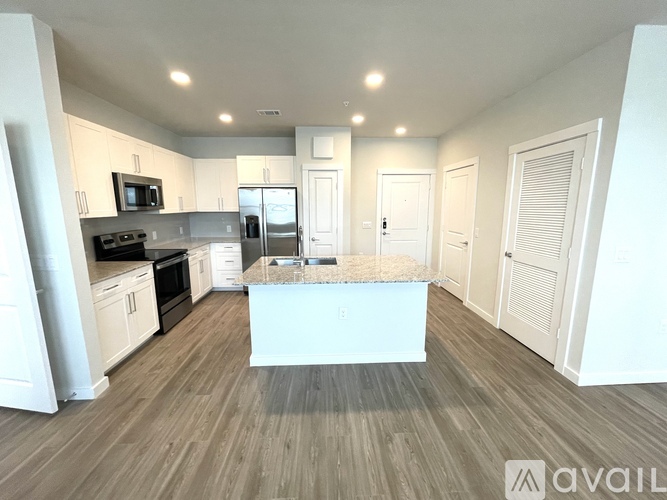 A kitchen with a white island in the middle of the room.