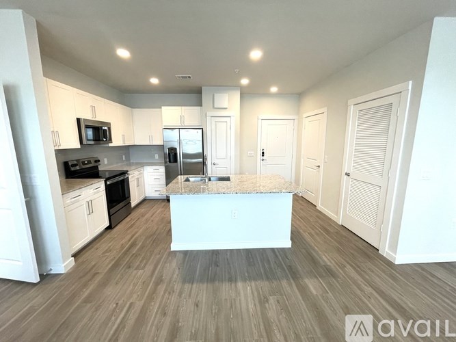 A kitchen with a white island in the middle of the room.