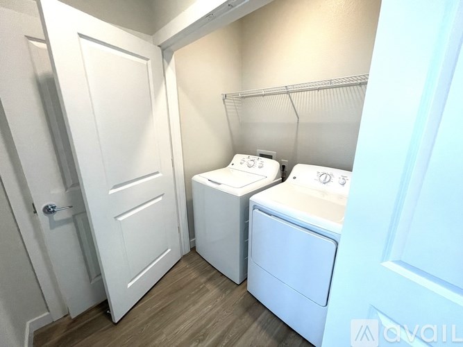 A small laundry room with a washer and dryer.
