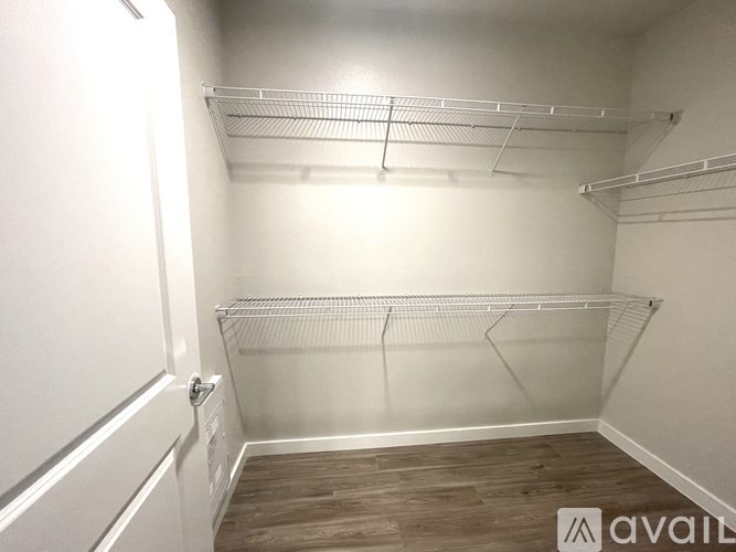 A walk-in closet with shelves and a door.