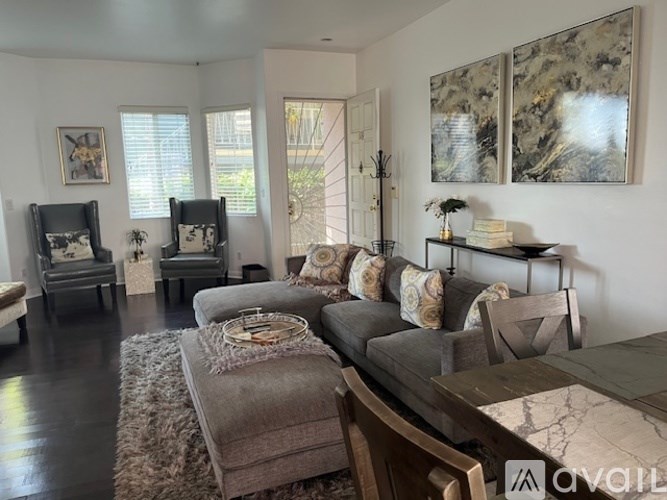 A living room with a grey couch and a wooden table.
