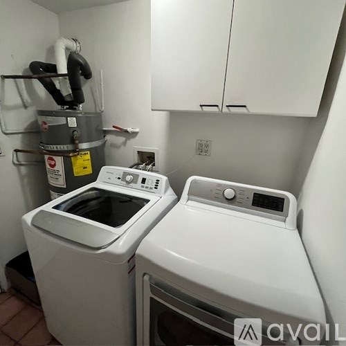 A washing machine and dryer in a small laundry room.
