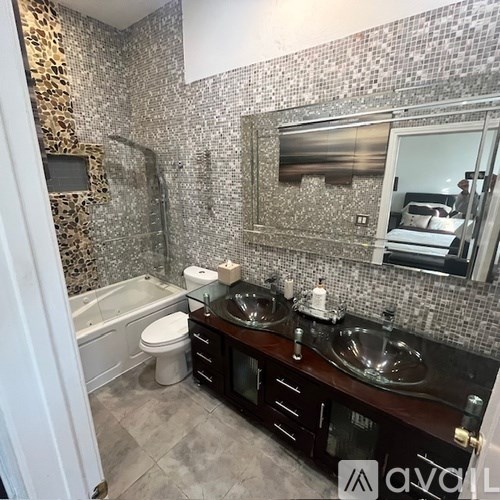 A bathroom with a leopard print shower curtain and a white toilet.