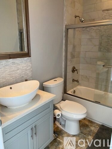 A bathroom with a white toilet and a white sink.
