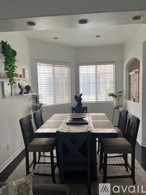 A dining room with a table set for four.