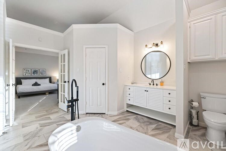 A bathroom with a white chair and a white sink.