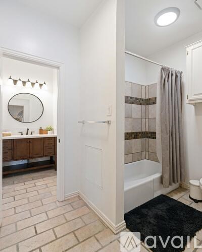 A bathroom with a shower, toilet, and sink.