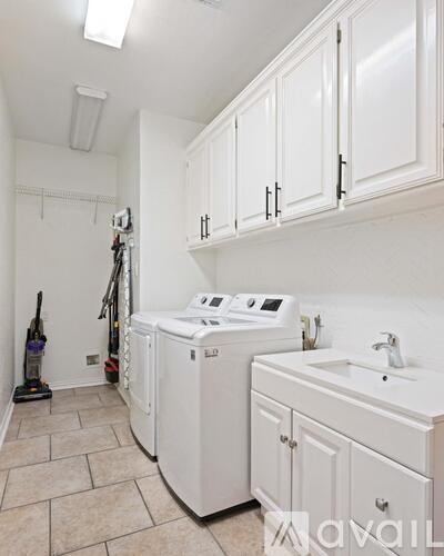 A white laundry room with a washer and dryer.
