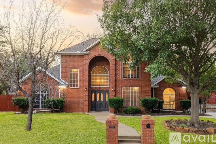 A house with a brick facade and a large front yard.