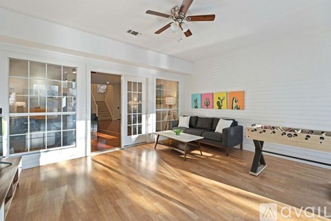 A living room with a black couch and a coffee table.