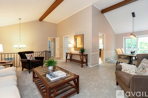 A living room with a wooden coffee table and a couch.
