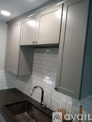 A kitchen with a sink and cabinets.