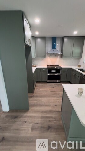 A modern kitchen with a stove top oven and a range hood.