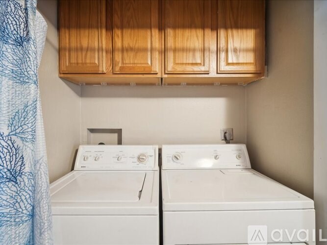 A washer and dryer are sitting next to each other in a small room.