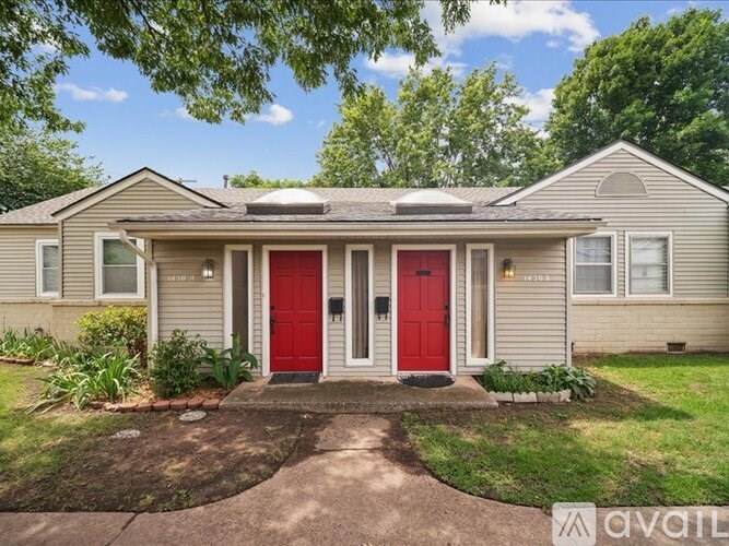 A house with a red door is for sale.