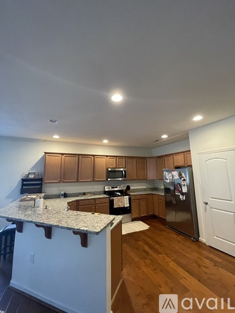 A kitchen with wooden cabinets and a granite countertop.