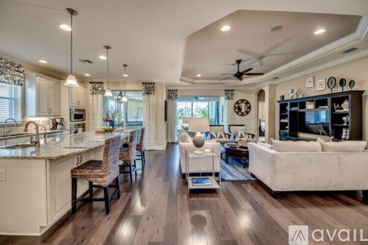 A modern kitchen with a dining area and a living room.
