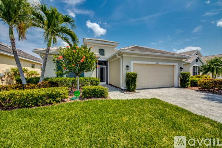 A house with a white garage door and a green lawn.