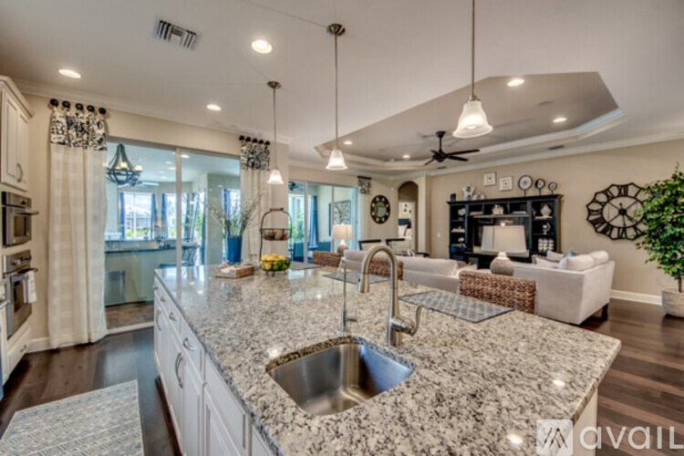 A kitchen with a granite countertop and a sink.