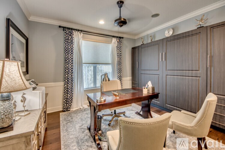 A well-lit dining room with a wooden table and chairs.