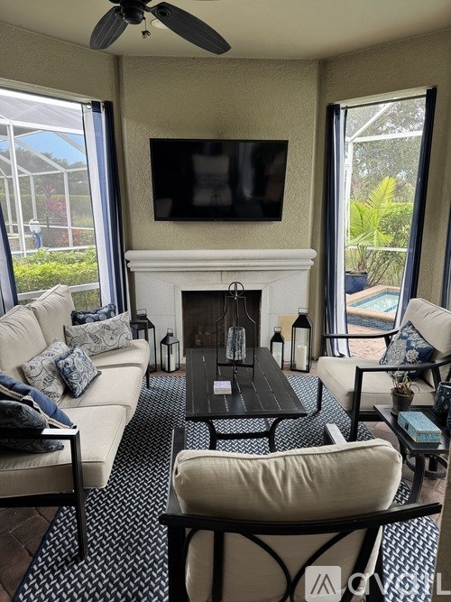 A living room with a white couch and a ceiling fan.