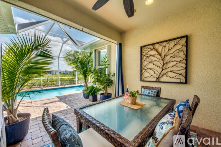 A table with a plant on it is in the middle of a patio.