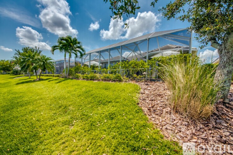 A lush green lawn with a building in the background.
