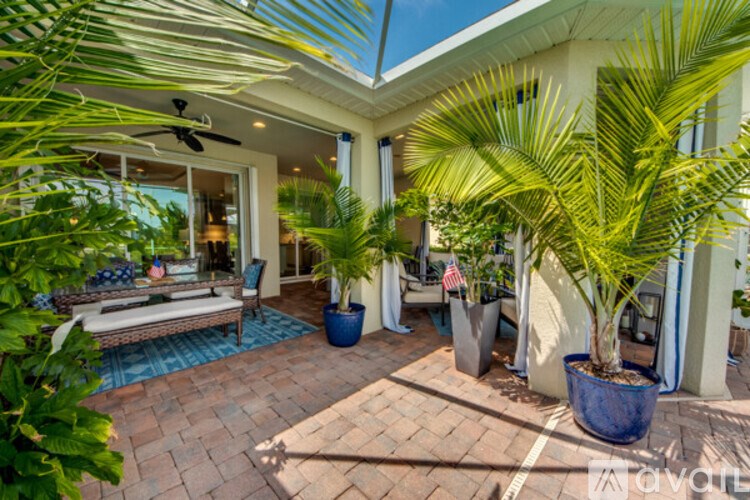 A patio with a table and chairs under a roof.