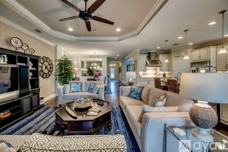 A living room with a white couch and a coffee table.