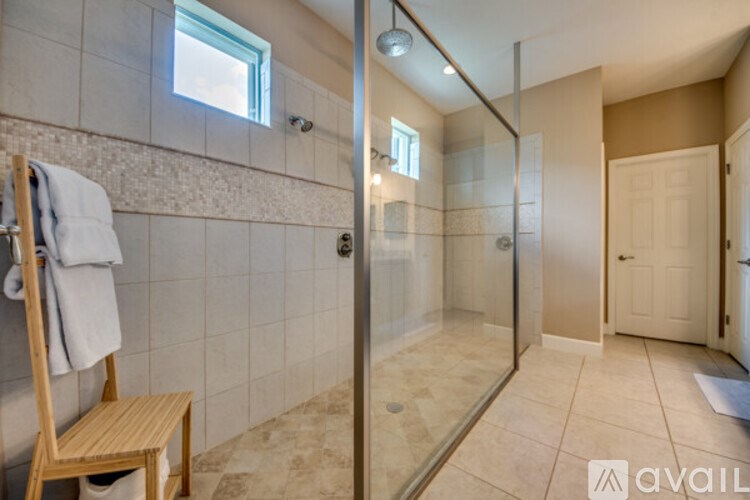 A bathroom with a walk-in shower and a towel rack.
