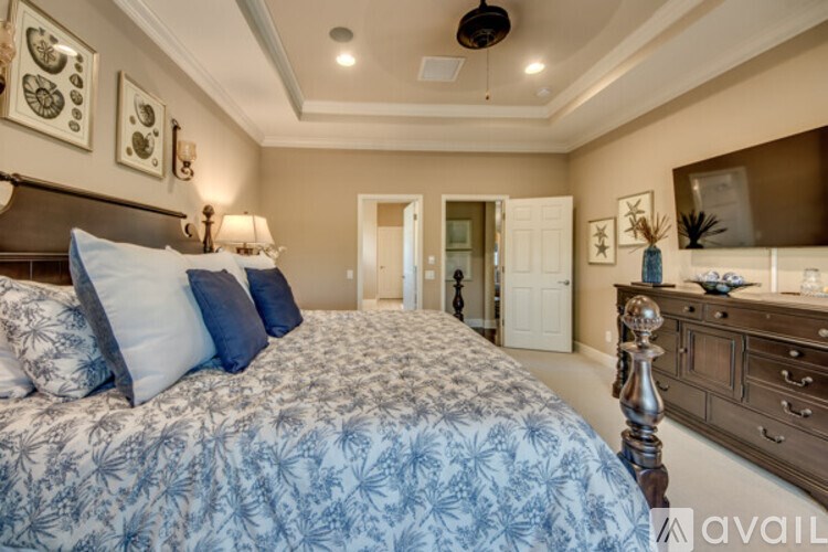 A bedroom with a large bed and a dresser.