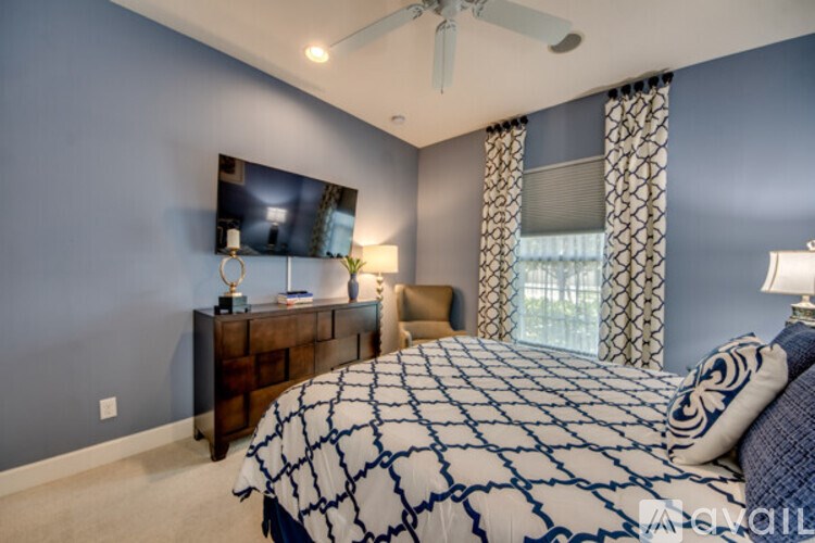 A bedroom with a large bed and a flat screen TV mounted on the wall.