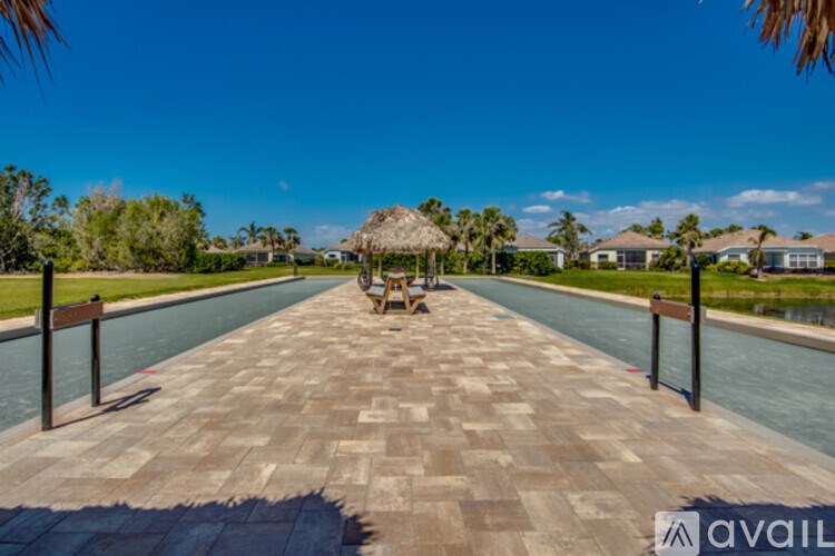 A walkway with a bench in the middle of a pool.