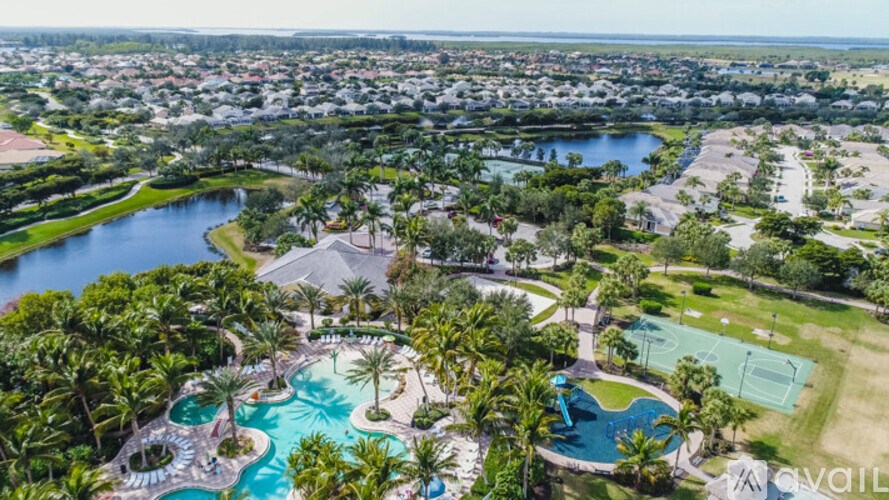 A bird's eye view of a resort with a pool and palm trees.