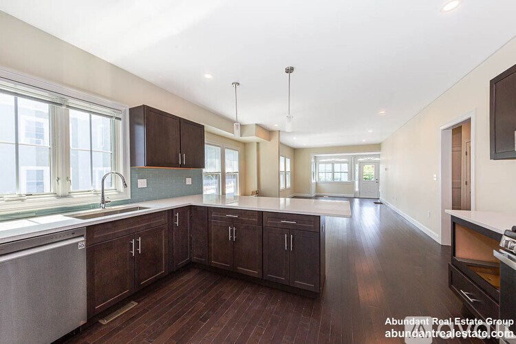 A kitchen with dark wood floors and cabinets.