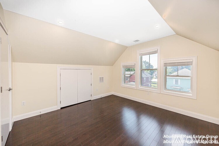 A room with a white ceiling and wooden floors.