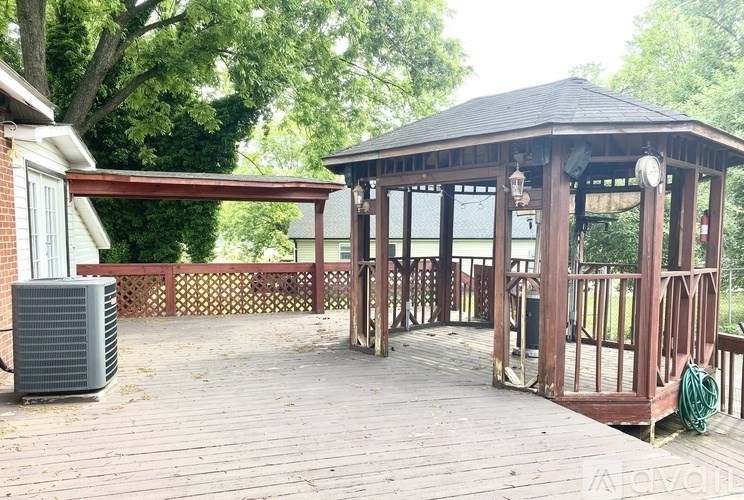 A gazebo is surrounded by a wooden deck.