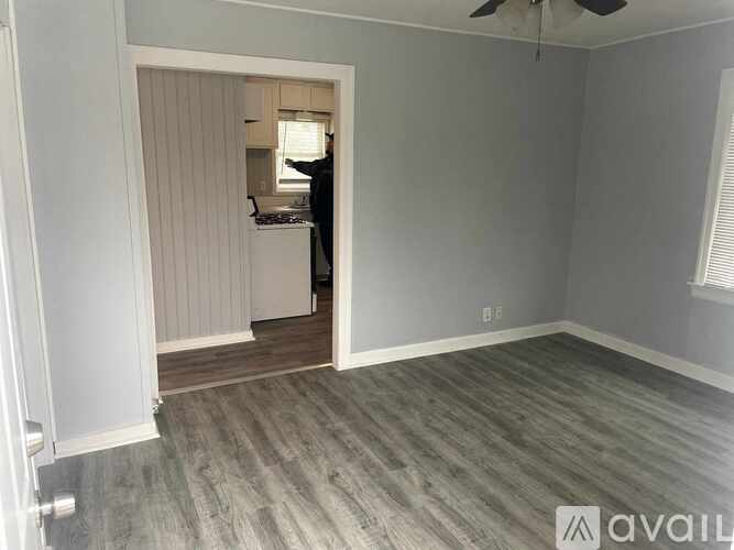 A room with a wooden floor and a ceiling fan.