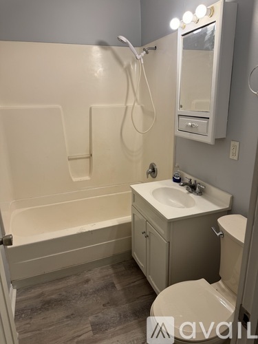 A bathroom with a toilet, sink, and bathtub.