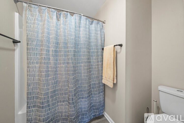 A blue shower curtain in a bathroom.