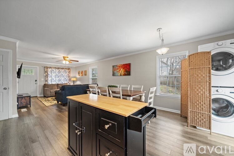 A kitchen with a washing machine in the dryer section.