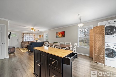 A kitchen with a washing machine in the dryer section.