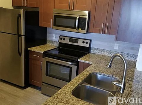 A kitchen with granite countertops and stainless steel appliances.