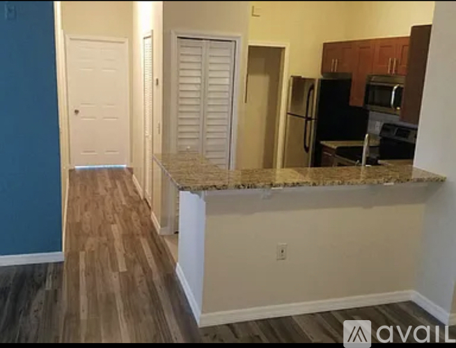 A kitchen area with a countertop and cabinets.