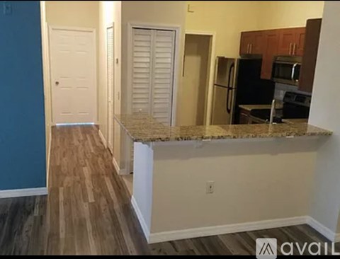 A kitchen area with a countertop and cabinets.